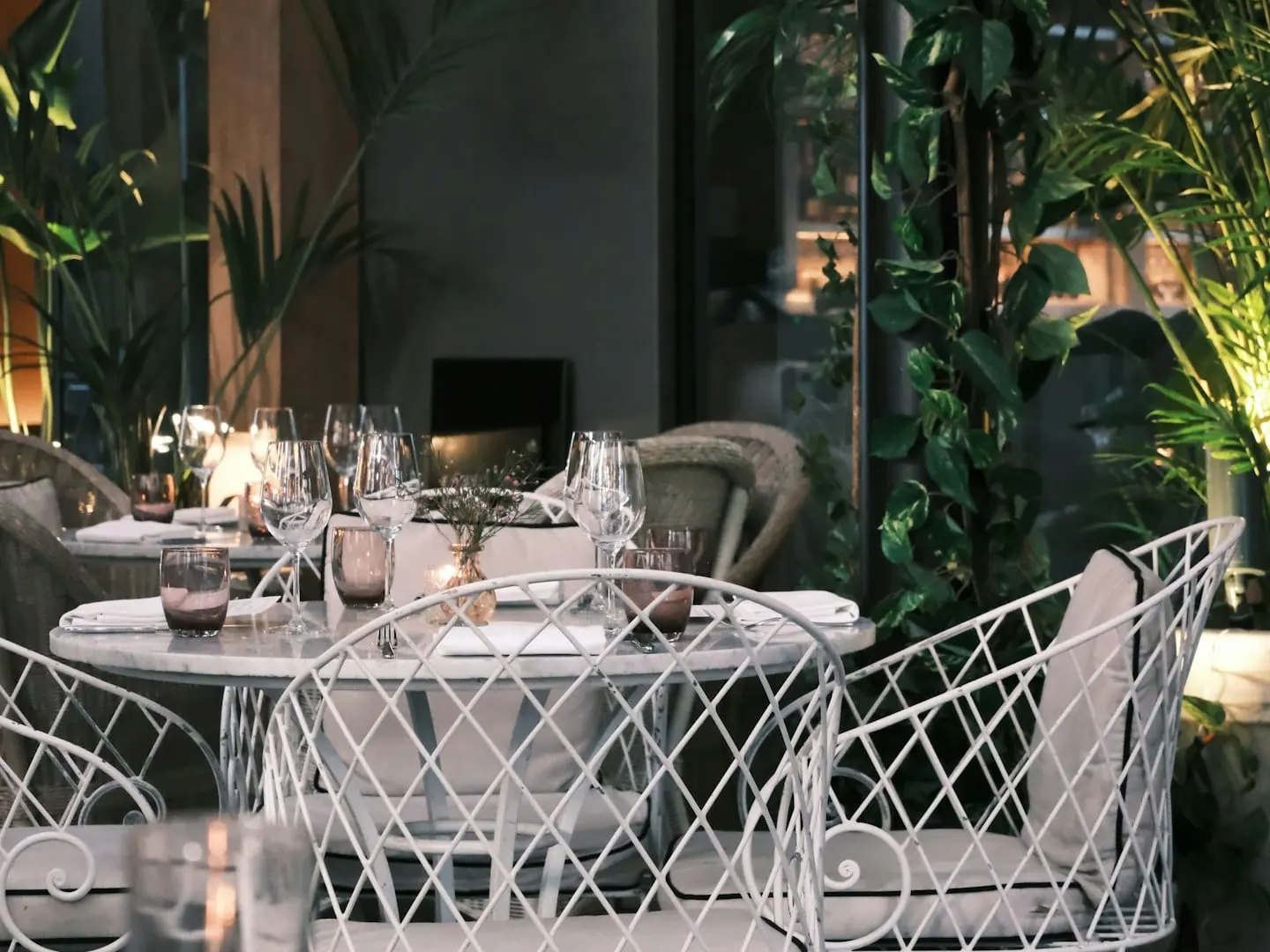 Outdoor dining space arranged among greenery